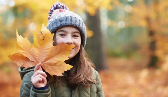 Girl with an autumn leaf